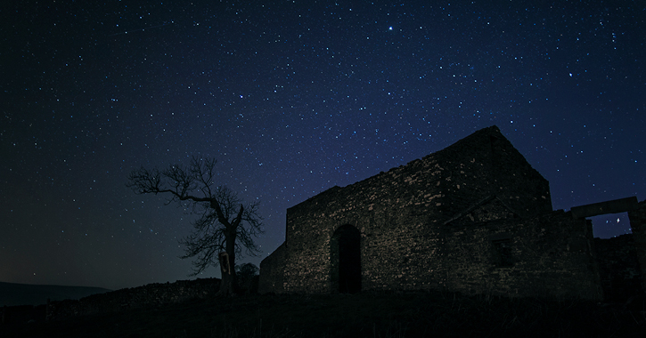 Abandoned cottage in the Durham Dales under a dark starry sky